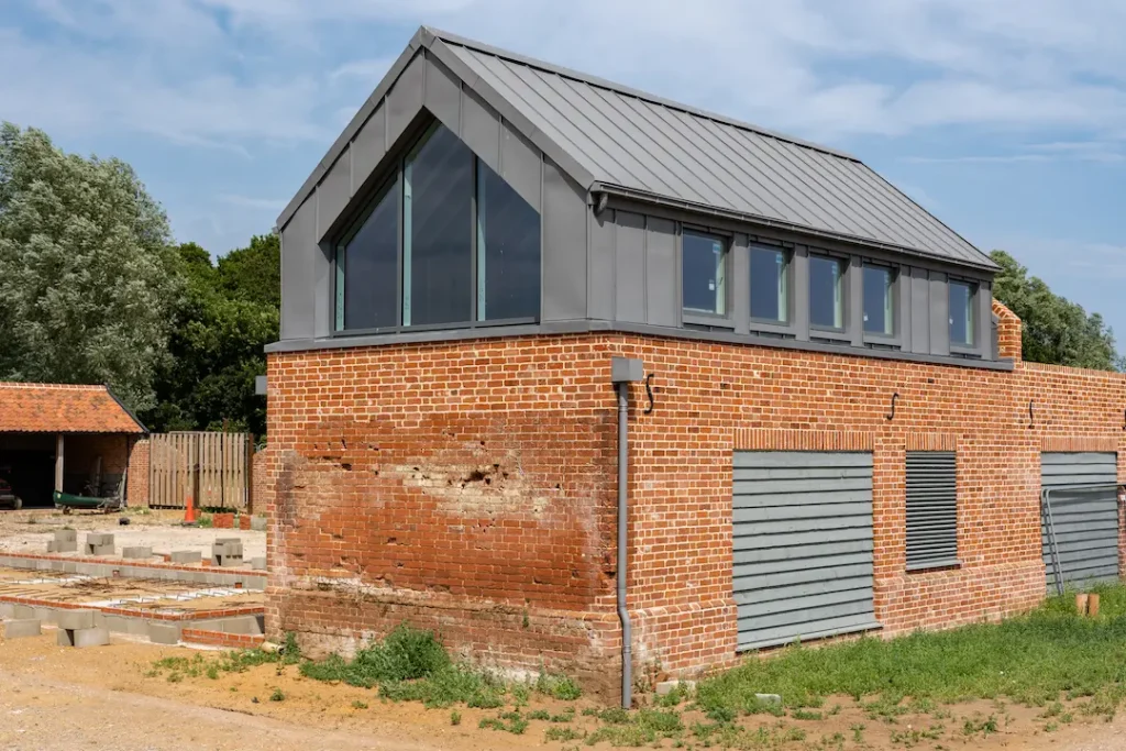 a brick building with a grey roof