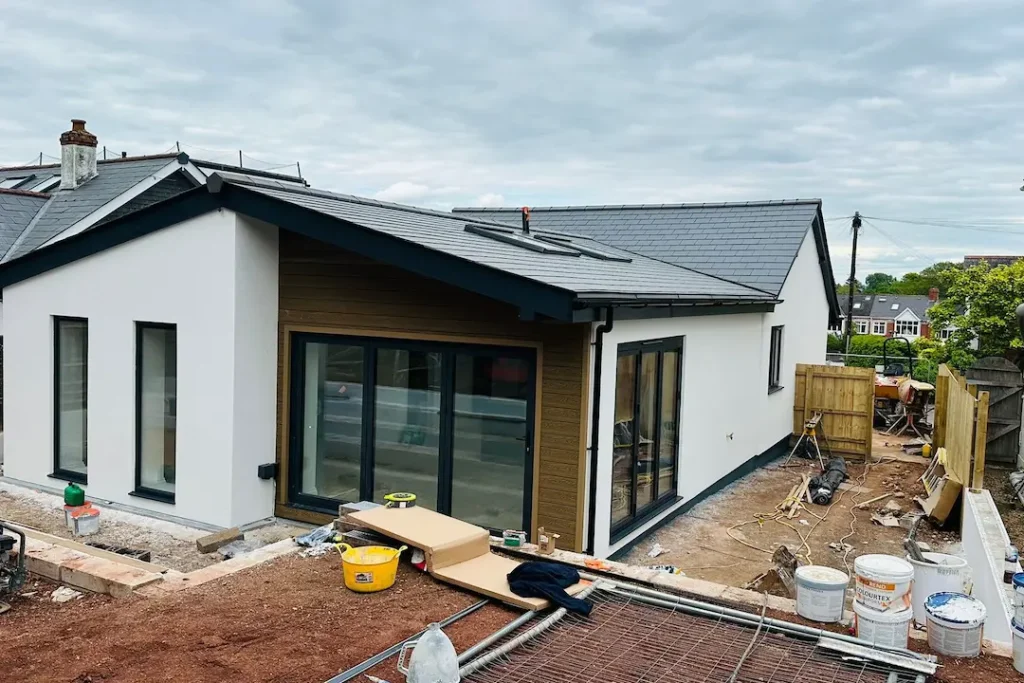 a house under construction with a fence and a fence